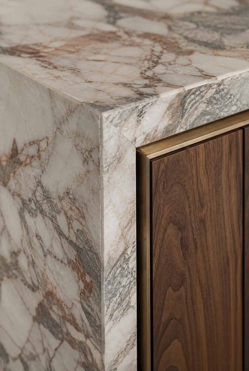 X4 Design and Build luxury marble and walnut joinery detail with thick stone edge, brass profile, clean corner junction, and refined cabinet finishing